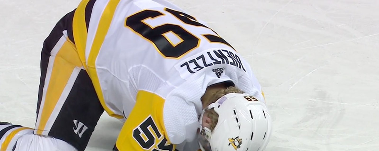 Guentzel takes a slapshot to the head as he's cross-checked to the ice 