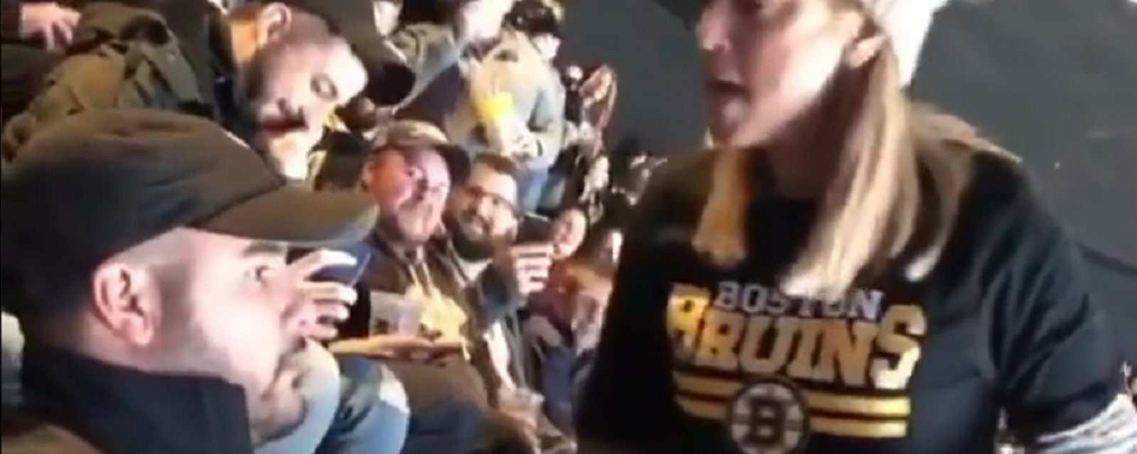 Bruins fan goes mental after someone spills food on her at the game.