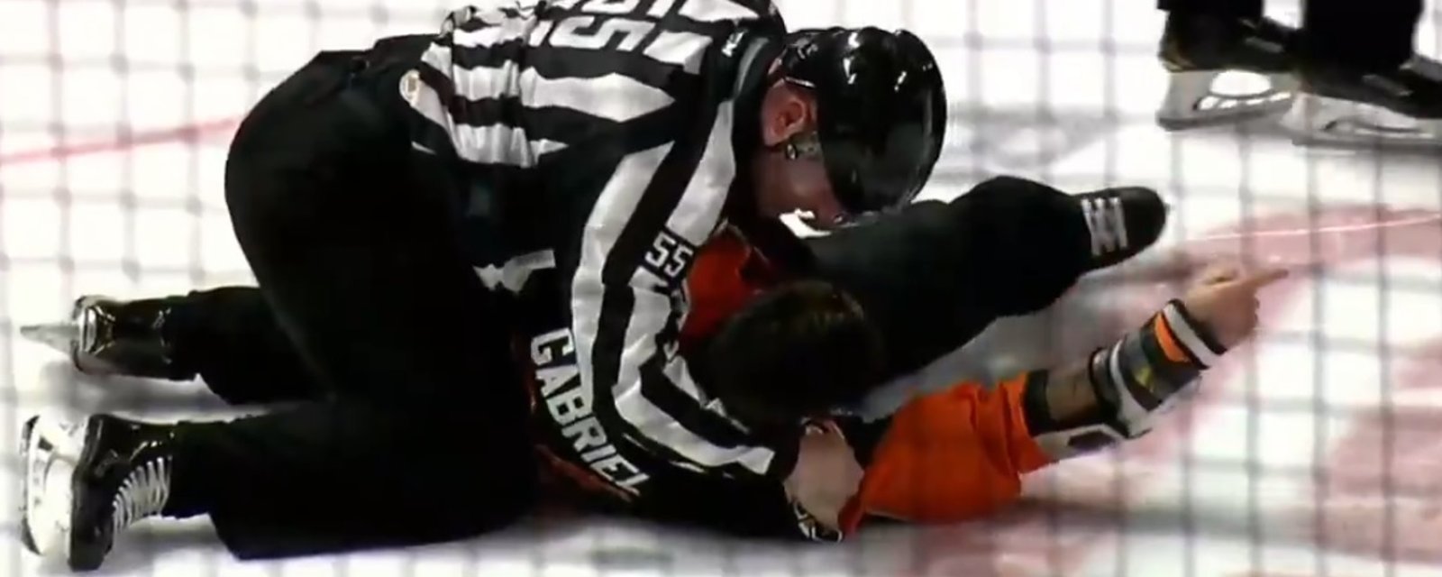 Linesman Richard Jondo slams Kurtis Gabriel to the ice after he refuses to stop fighting.