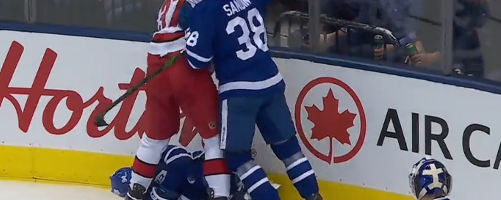 Toronto's Tyson Barrie leaves the game after being sent head first into the boards.