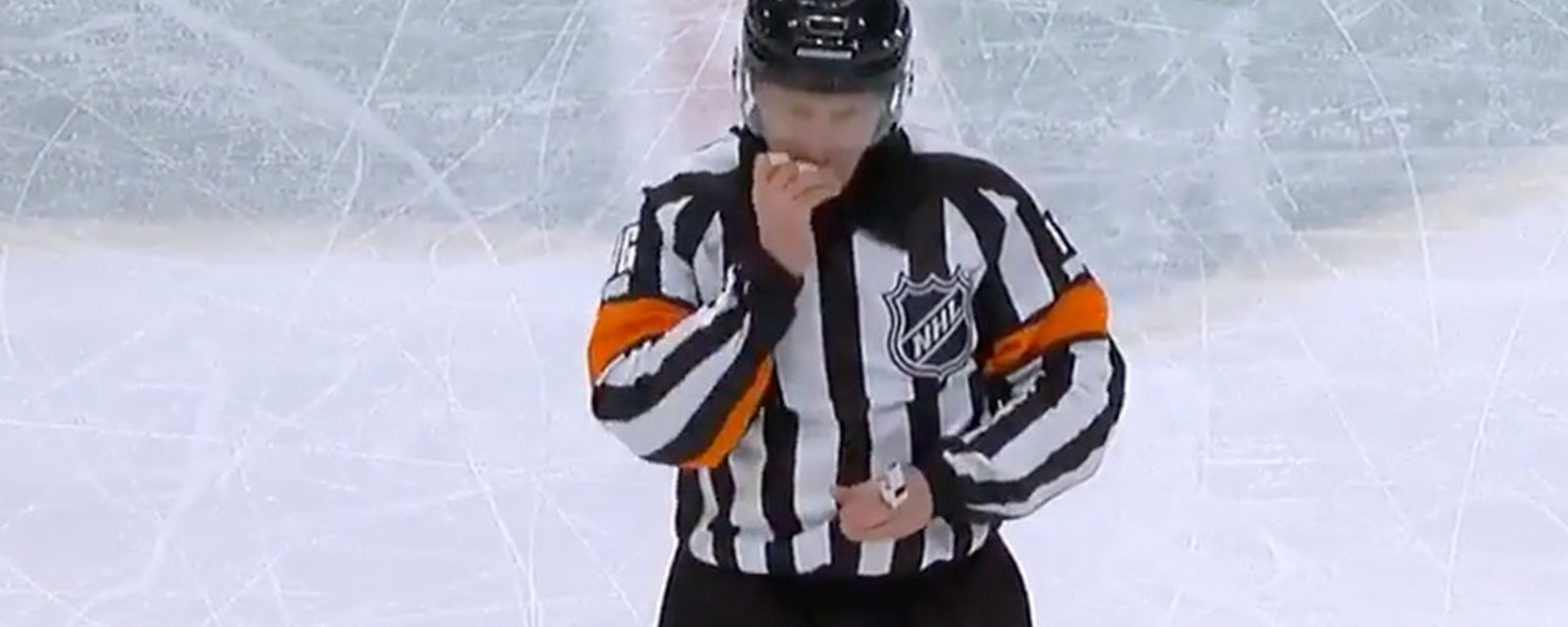 Referee Kelly Sutherland pops his teeth in before making penalty call
