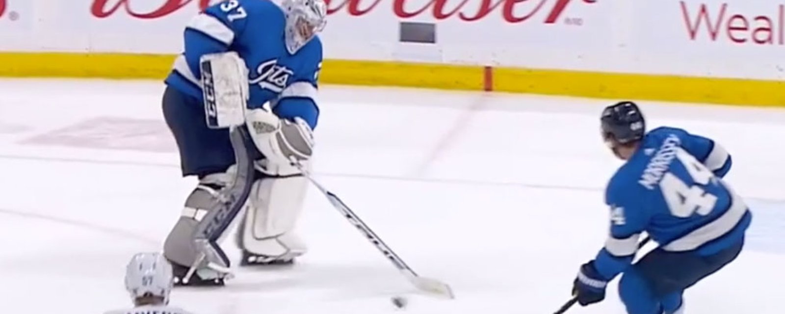 Hellebuyck takes shot at the empty net but totally gets shut down! 