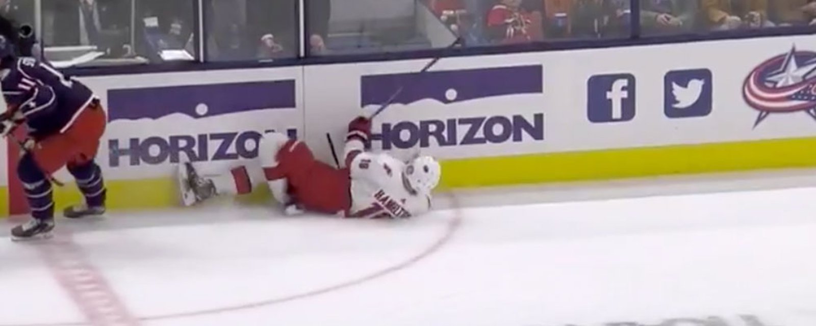 Dougie Hamilton falls awkwardly, folding his knee under him in the process