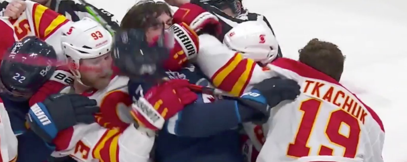 Flames’ Bennett holds Jets’ Lowry while Tkachuk throws some punches