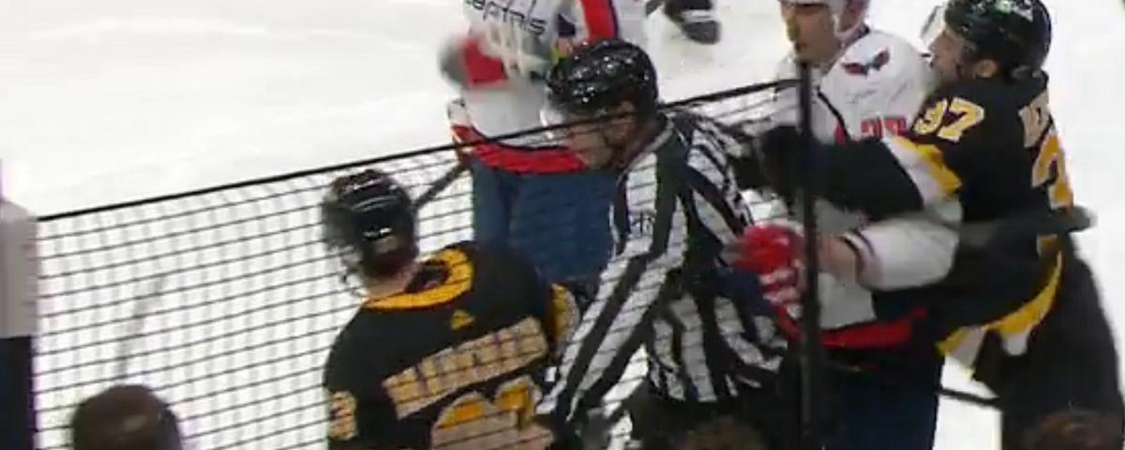 Patrice Bergeron restrains Zdeno Chara as he goes after Brad Marchand.