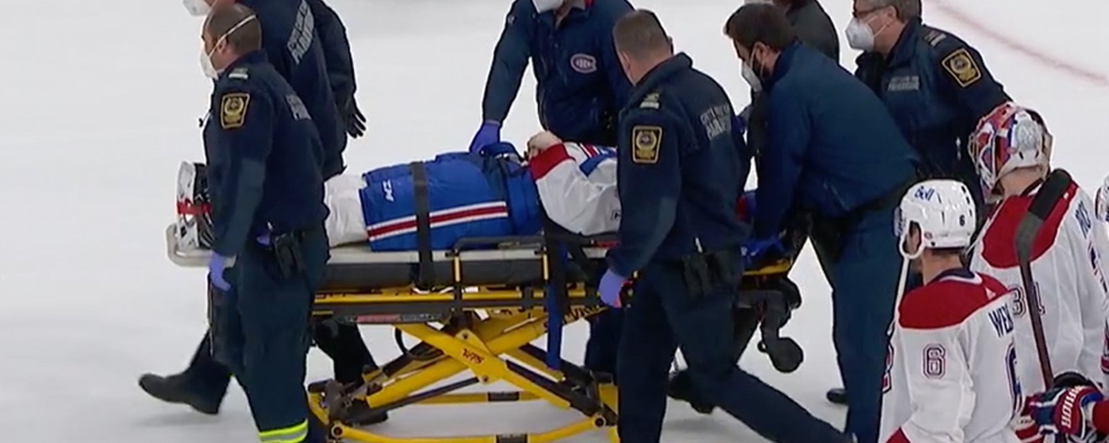 Jake Evans leaves on a stretcher after brutal hit from Mark Scheifele