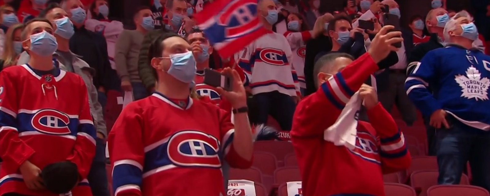 Canadian fans sing the national anthem at an NHL hockey game for the first time all season.