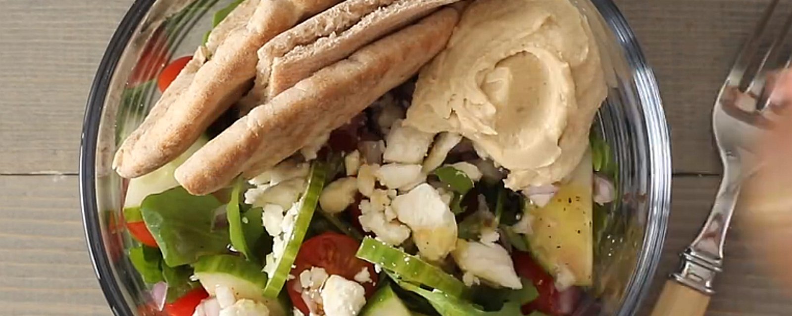 Salade grecque servie avec hummus, parfaite pour un lunch santé