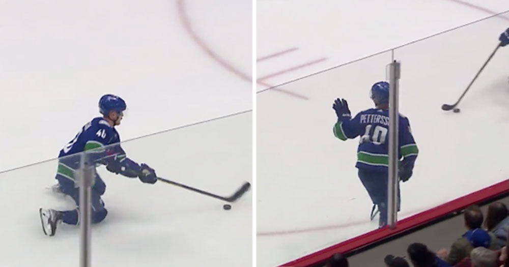 Elias Pettersson tries to waive off a soft call from the refs