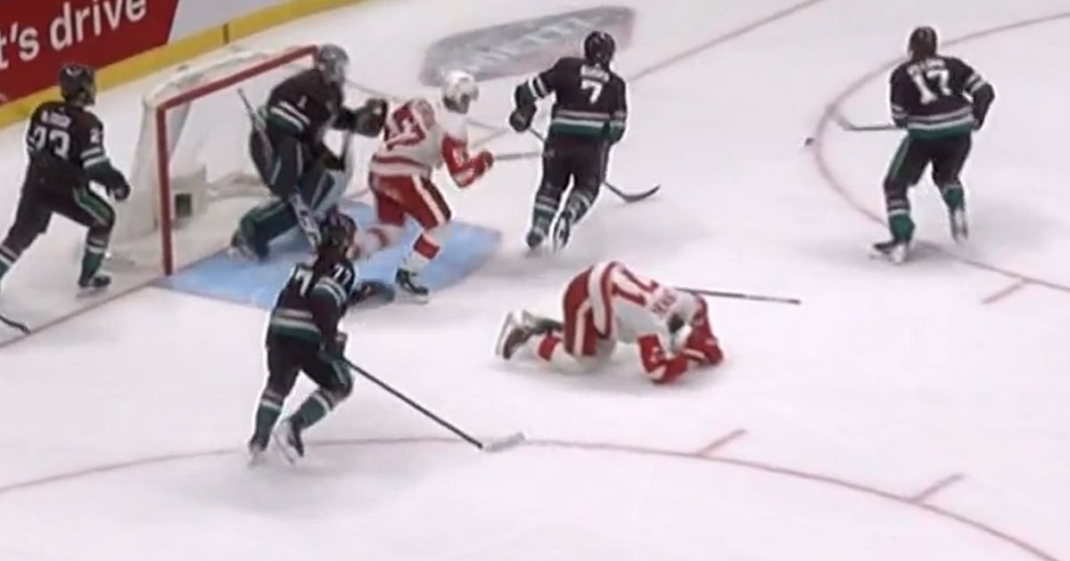 Dylan Larkin injured after a cross check to the back.